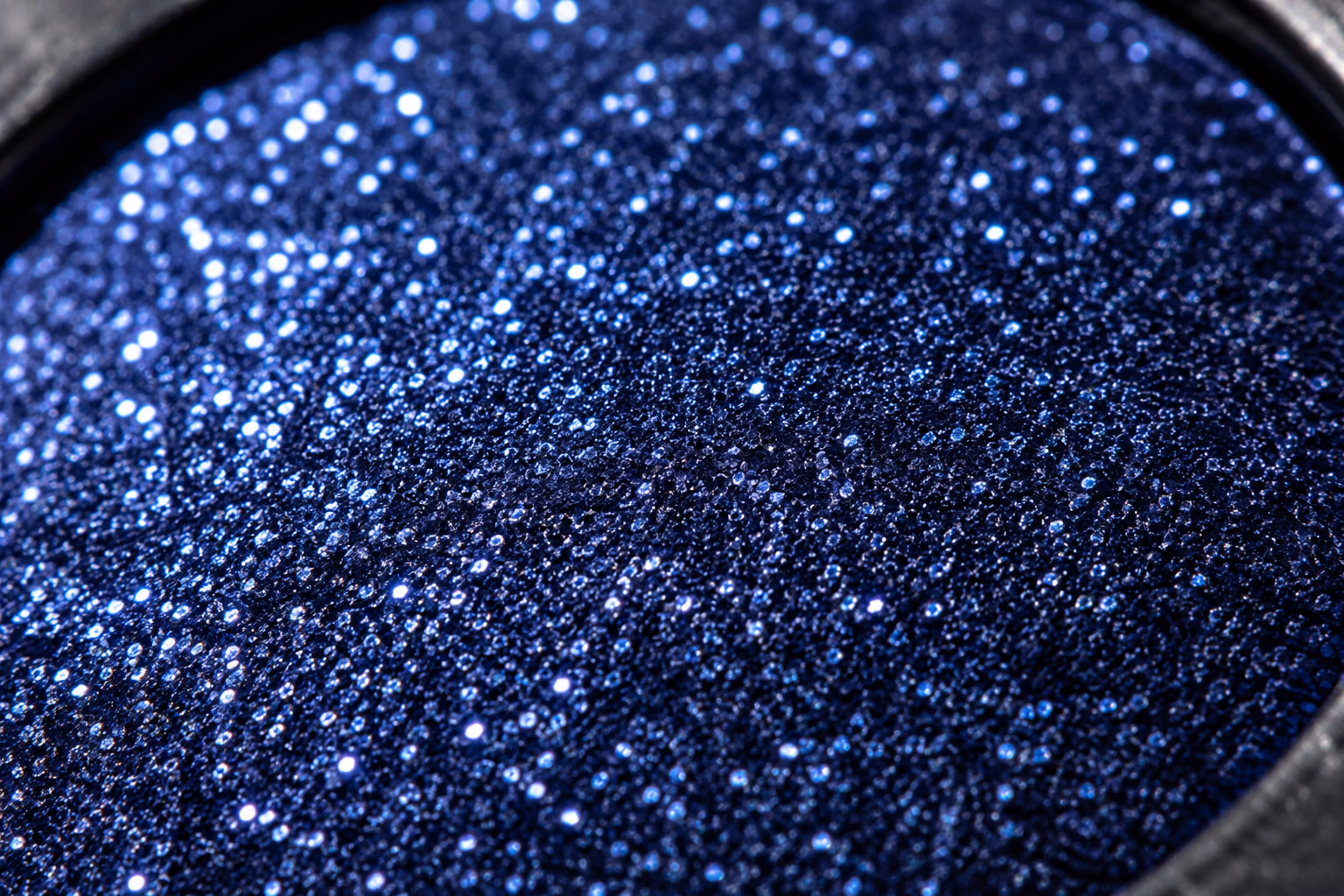 Close-up of a blue sparkling cosmetic texture.