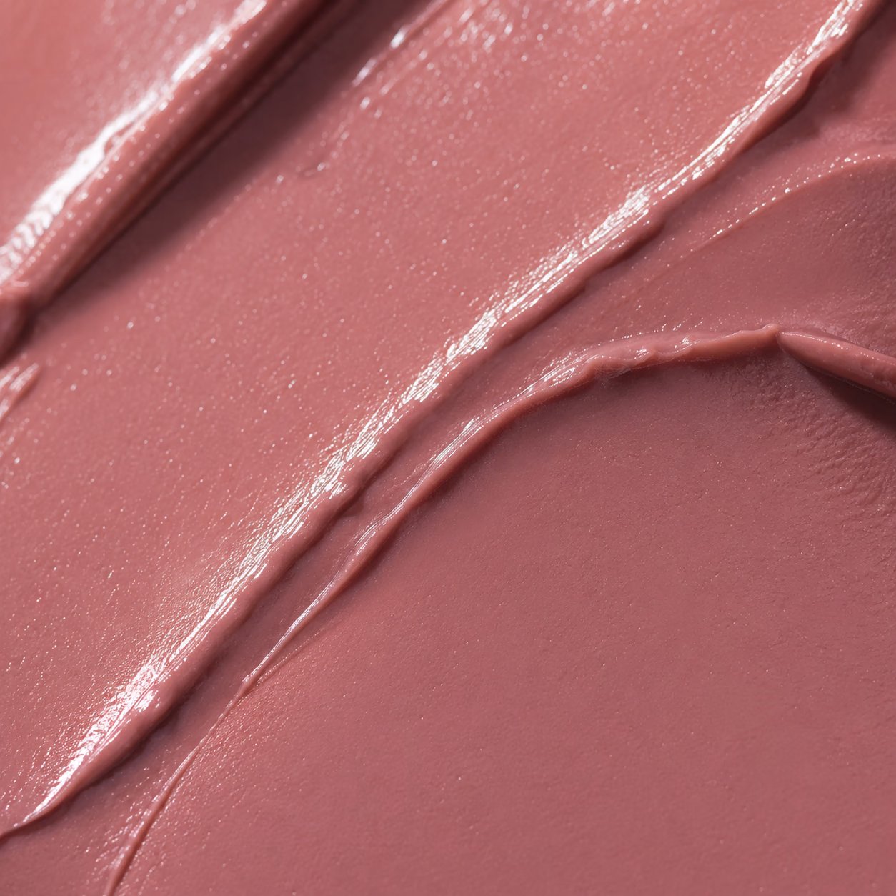 Close-up of a dusty rose cream cosmetic texture.