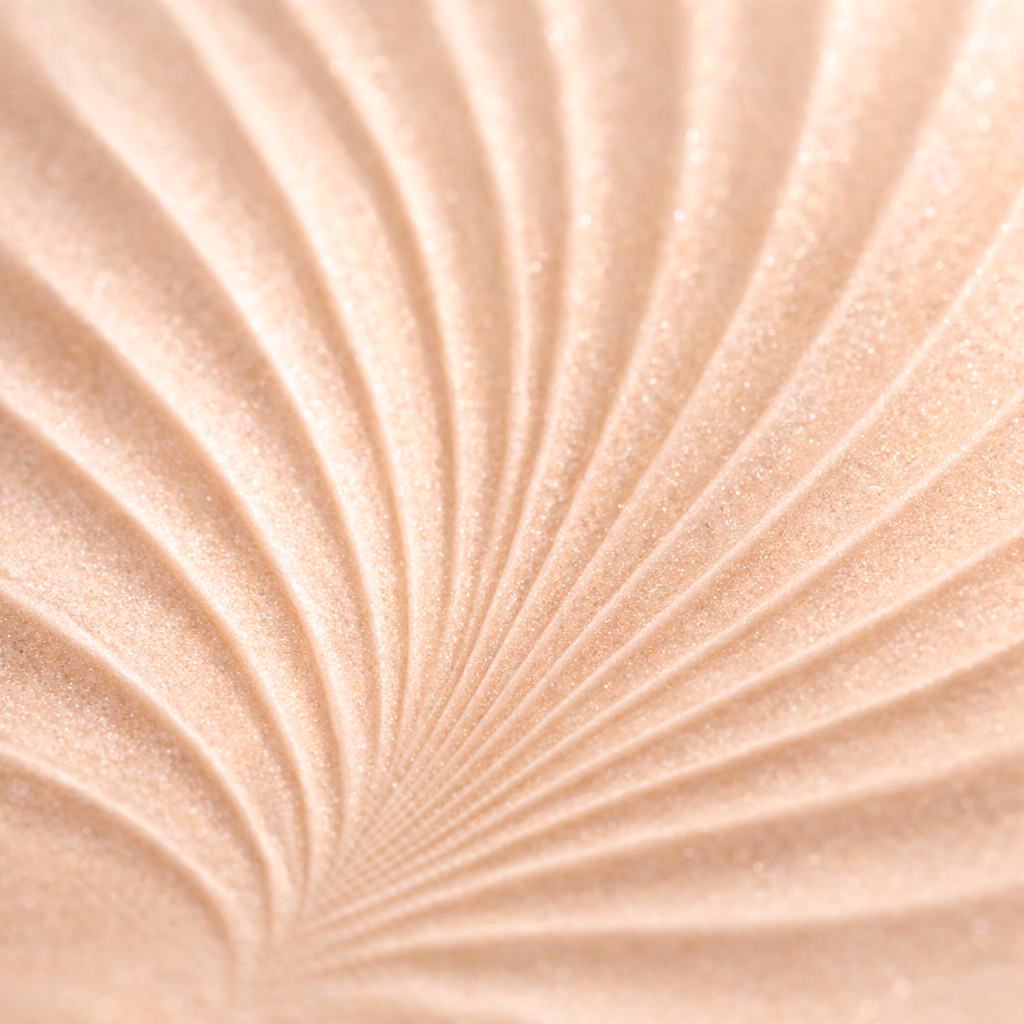 Close-up of a peach shimmer cosmetic texture with a radial pressed pattern.